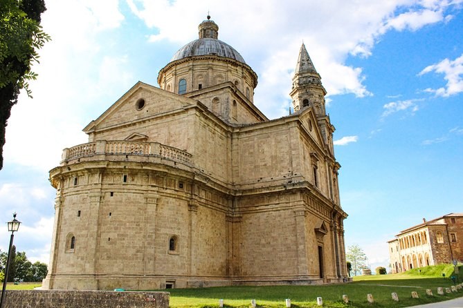 The Tempio di San Biagio standing alone on its lawn below Montepulciano's walls, its dome and single tower against the sky